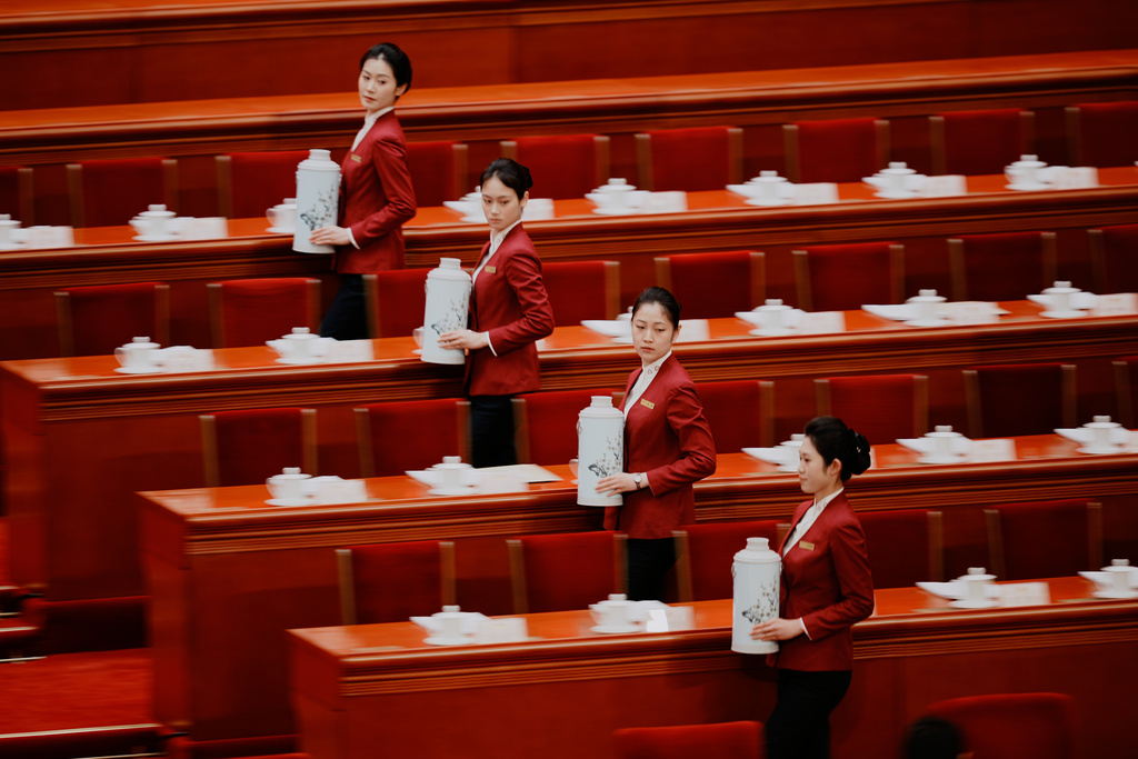 Hostesses prepare tea for delegates before the start of plenary session for National People's Congress (NPC) at the Great Hall of the People in Beijing, China, Monday, March 9, 2026. (AP Photo/Vincent Thian)
