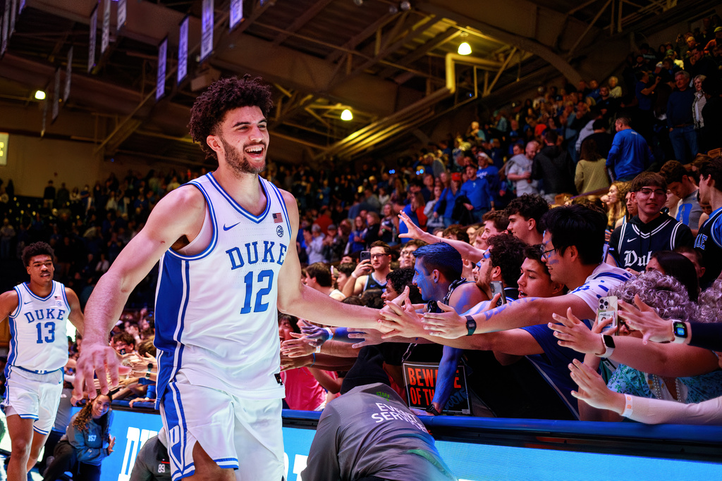Duke's Cameron Boozer (12) greets fans after his team defeated Syracuse in an NCAA college basketball game in Durham, N.C., Monday, Feb. 16, 2026. (AP Photo/Ben McKeown)