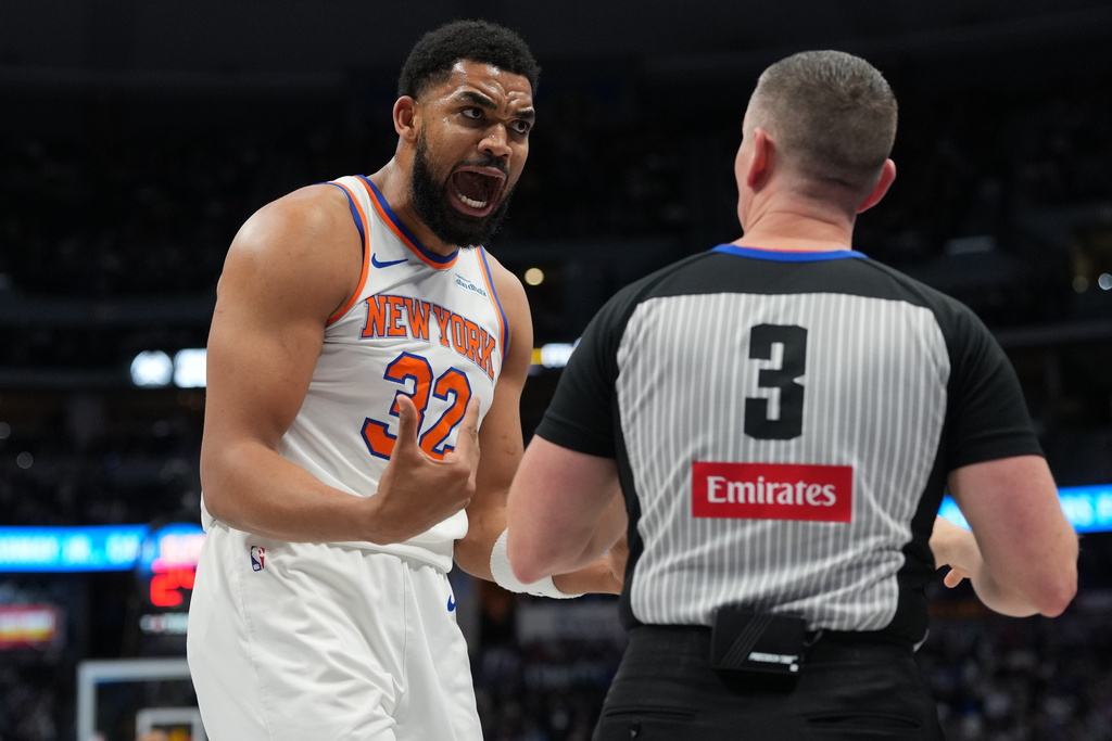 New York Knicks center Karl-Anthony Towns argues after he was called for a foul by referee Nick Buchert in the first half of an NBA basketball game against the Denver Nuggets Friday, March 6, 2026, in Denver. (AP Photo/David Zalubowski)