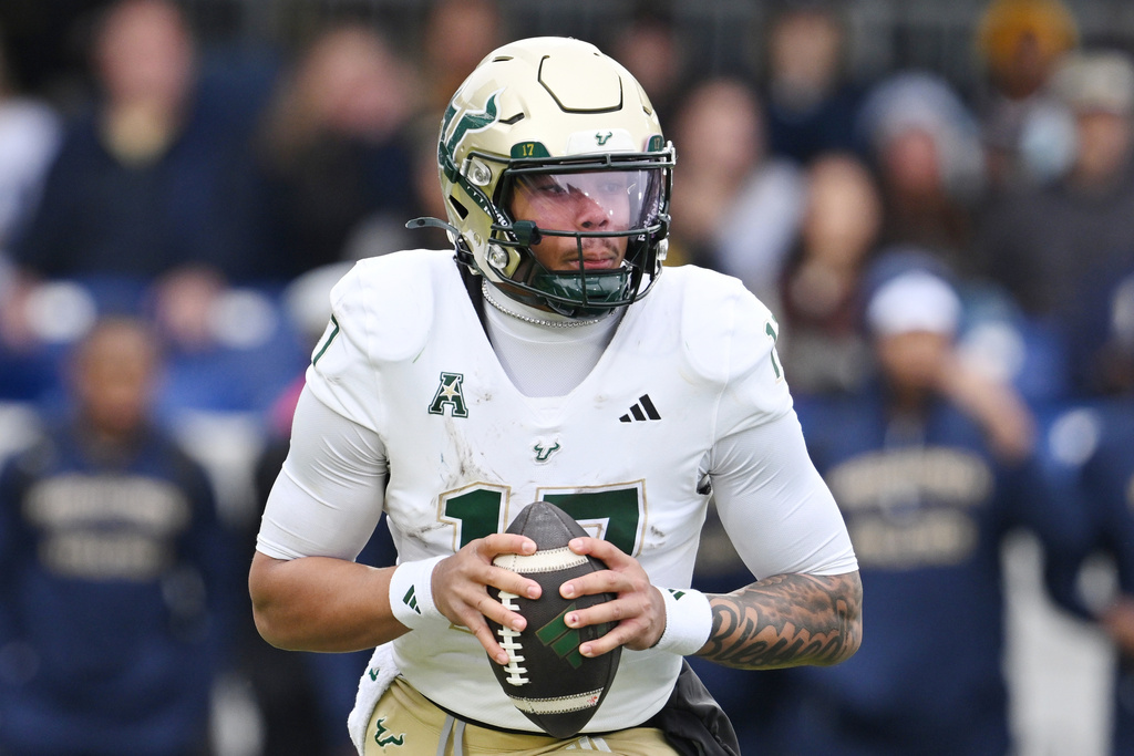 FILE - South Florida quarterback Byrum Brown (17) runs against Navy during the first half of a NCAA college football game, Saturday, Nov.15, 2025, in Annapolis, Md.(AP Photo/Gail Burton, File)