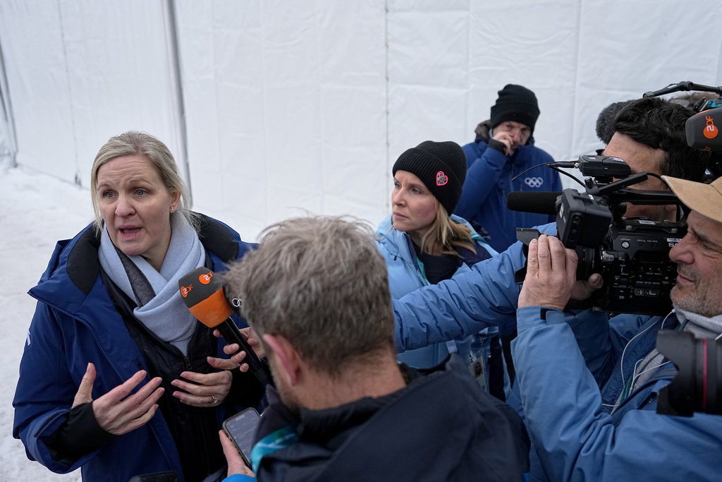 International Olympic Committee President Kirsty Coventry, left, talks to the media at the start house of the sliding center at the 2026 Winter Olympics, in Cortina d'Ampezzo, Italy, Thursday, Feb. 12, 2026. (AP Photo/Fatima Shbair)