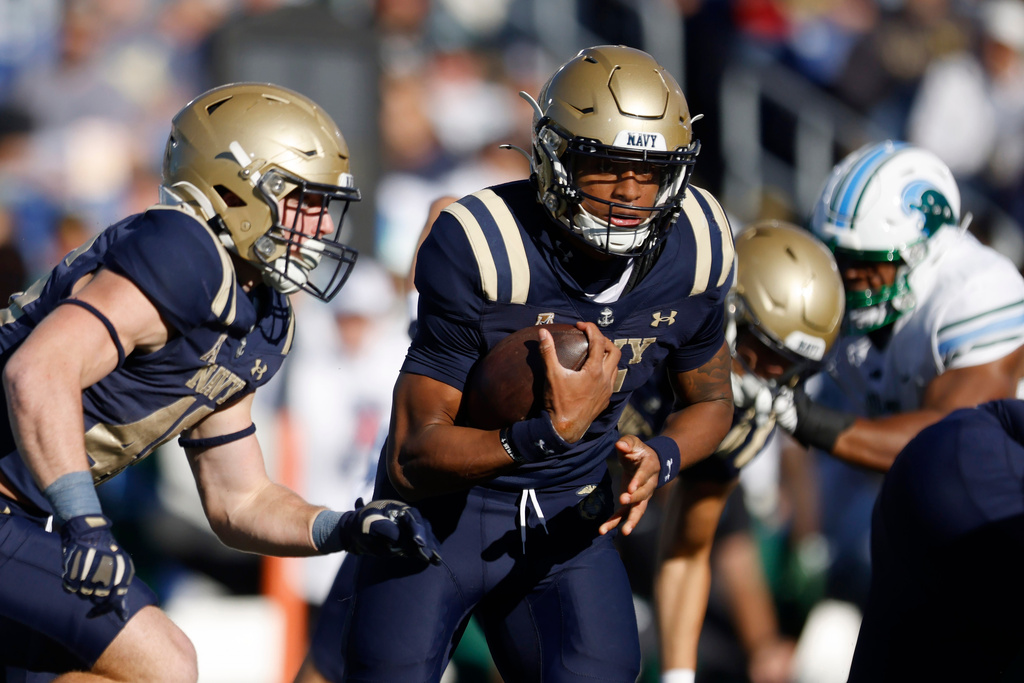 FILE - Navy quarterback Braxton Woodson (5) rushes downfield during an NCAA football game against Tulane, Nov. 16, 2024, in Annapolis, Md. (AP Photo/Mike Buscher, File)
