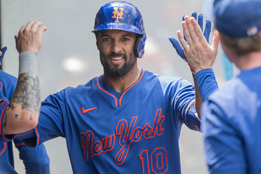 New York Mets' Marcus Semien is congratulated by his teammates after hitting a solo home run off Cleveland Guardians starting pitcher Foster Griffin during the second inning of a baseball game, Thursday, Aug. 6, 2026, in Cleveland. (AP Photo/Phil Long)