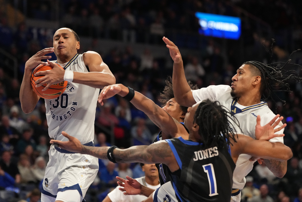George Washington's Rafael Castro (30) reaches for a rebound as Saint Louis' Quentin Jones (1) watches during the second half of an NCAA college basketball game Tuesday, Jan. 27, 2026, in St. Louis. (AP Photo/Jeff Roberson)