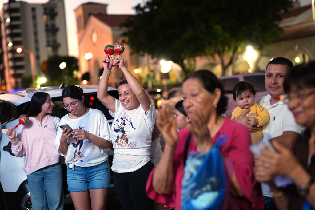 Nicaraguans sing in praise of the Virgin Mary at one of dozens of open-air altars set up near St. John Bosco Catholic Church in celebration of the Dec. 8 feast of the Immaculate Conception, Sunday, Dec. 7, 2025, in Miami. (AP Photo/Rebecca Blackwell)