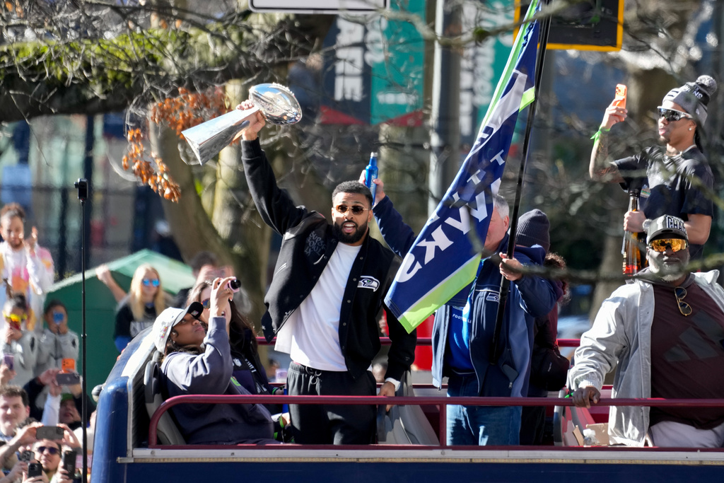 Seattle Seahawks players celebrate during the team's NFL football Super Bowl 60 parade and celebration, Wednesday, Feb. 11, 2026, in Seattle. (AP Photo/Stephen Brashear)
