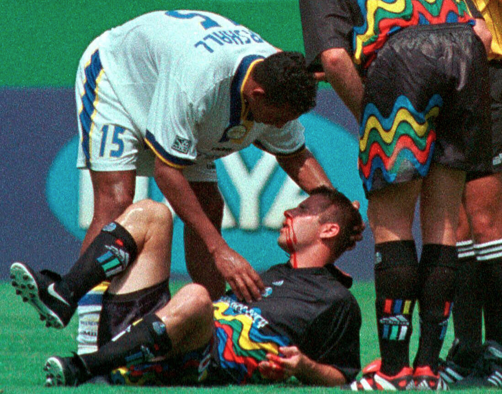 FILE - Miami Fusion's Tyrone Marshall (15) assists Kansas City Wizards' Scott Vermillion after the two collided while going up for a header in the first half of a soccer match Aug. 29, 1999, in Kansas City, Mo. (AP Photo/Ed Zurga, File)