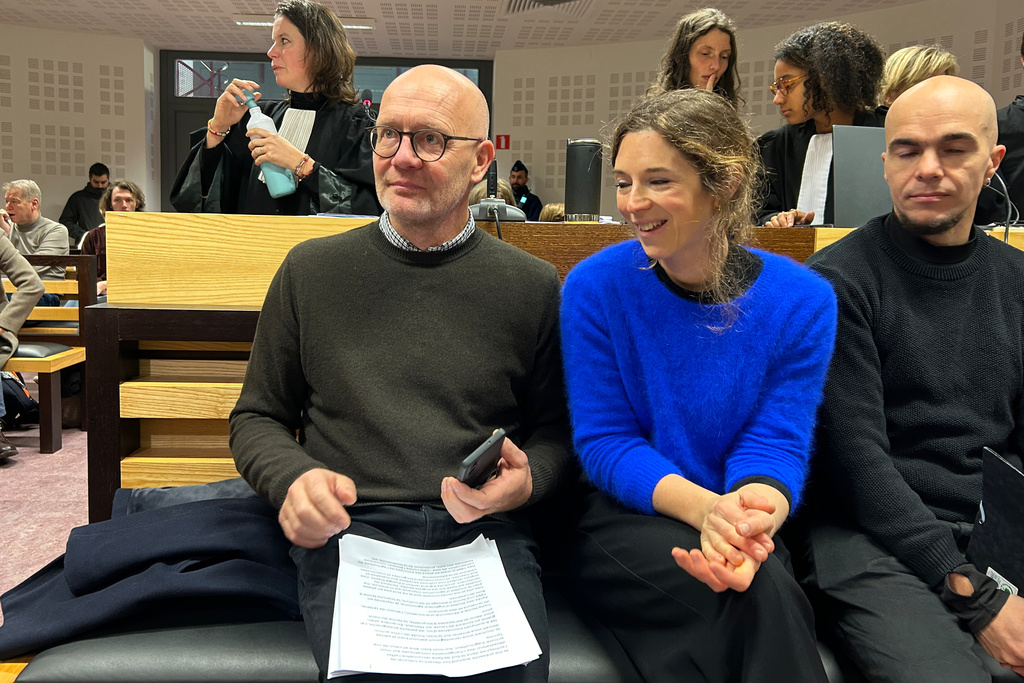 Belgian farmer Hugues Falys , center left, sits in a courtroom as French oil giant TotalEnergies is on trial, accused by Falys and three environmental groups of bearing responsibility for climate change, Wednesday, Nov. 19, 2025 in Tournai, Belgium. (AP Photo/Mark Carlson)