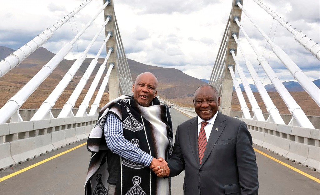 In this photo provided by the South African Government Communications and Information Services (GCIS), King of Lesotho Letsie III, left, shakes hand with South African President Cyril Ramaphosa following the official opening of the Senqu Bridge in Mokhotlong, Lesotho, Wednesday, April 22, 2026. (Elmond Jiyane/South African Government Communication and Information Services via AP)