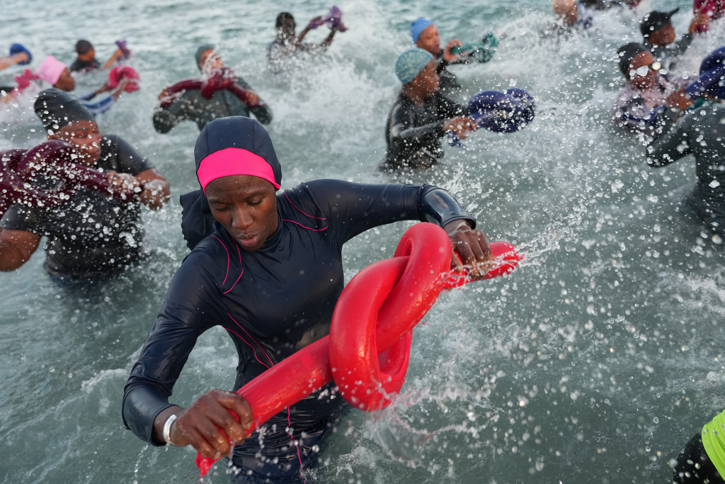 FILE - People take part in a group aquatic therapy session in the ocean in Dakar, Senegal, Saturday, Dec. 13, 2025. (AP Photo/Misper Apawu, File)