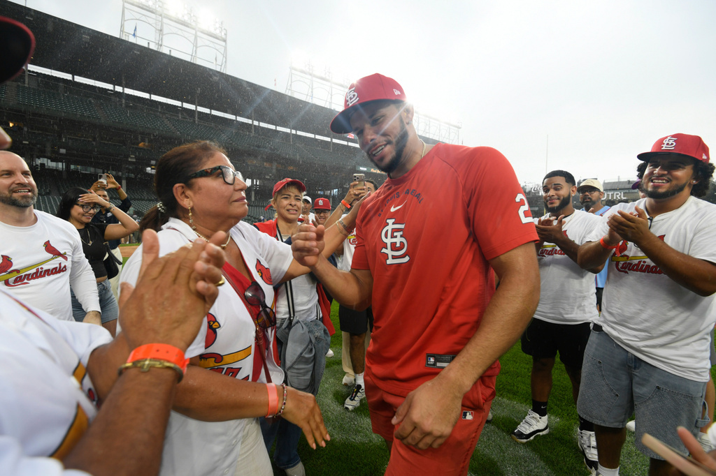 St. Louis Cardinals' Joshua Baez, right, celebrates with his mother Yris Carmen Baez, left, after defeating the Chicago Cubs in a baseball game in Chicago, Saturday, Aug. 15, 2026. (AP Photo/Paul Beaty)