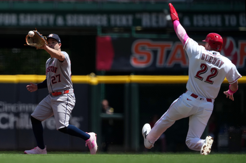 Houston Astros second baseman Jose Altuve receives a throw to start a double play as Cincinnati Reds' JJ Bleday, right, slides into second base during the second inning of a baseball game, Sunday, May 10, 2026, in Cincinnati. (AP Photo/Kareem Elgazzar)