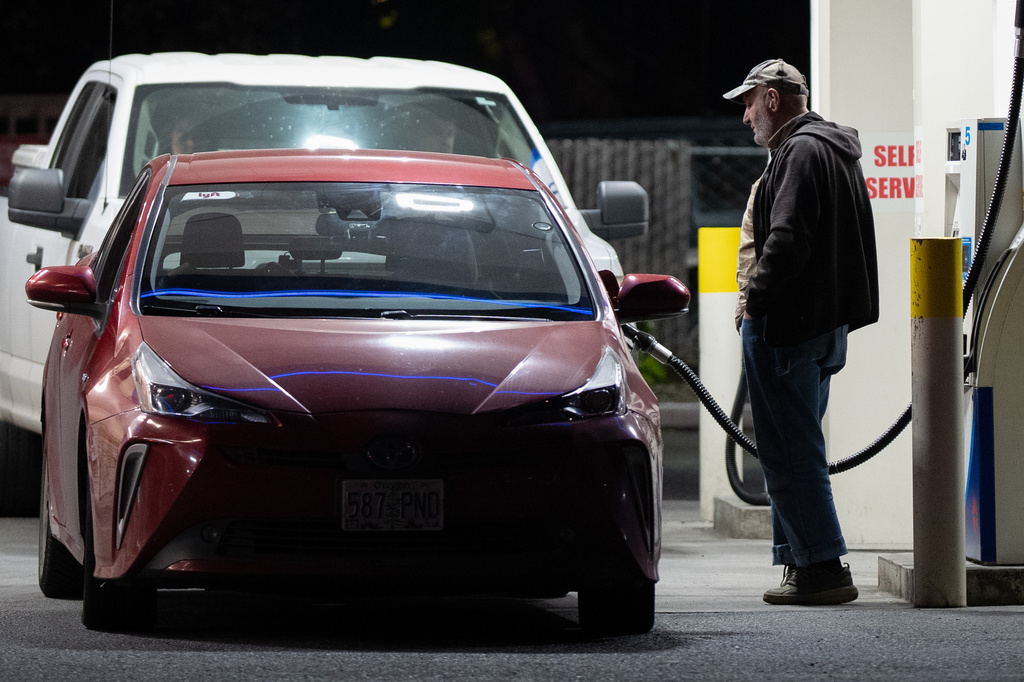 A person fills a tank with fuel at a gas station on Wednesday, May 6, 2026, in Portland, Ore. (AP Photo/Jenny Kane)