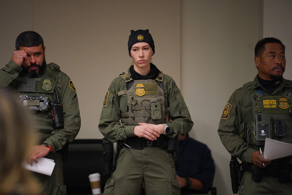 Federal agents look on as White House border czar Tom Homan holds a news conference at the Bishop Whipple Federal building on Wednesday, Feb. 4, 2026 in Minneapolis. (AP Photo/Ryan Murphy)