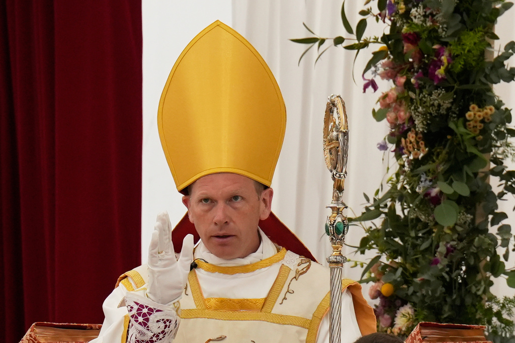 Newly consecrated Bishop Michael Goldade delivers his blessing at the end of his consecration ceremony in a tent set up outside the Society of St. Pius X seminary in Econe, Switzerland, Wednesday, July 1, 2026. (AP Photo/Baz Ratner)