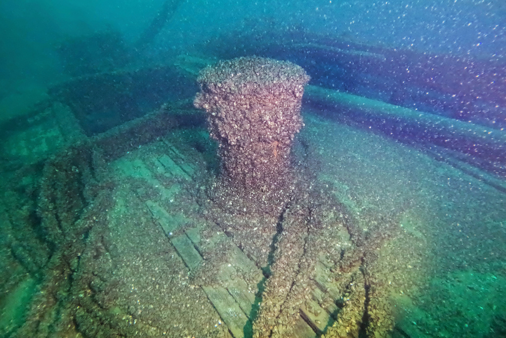 In this photo released by the Wisconsin Historical Society, quagga mussels cover the capstan of the F.J. King shipwreck in Lake Michigan on Aug. 23, 2025. (Wisconsin Historical Society via AP)