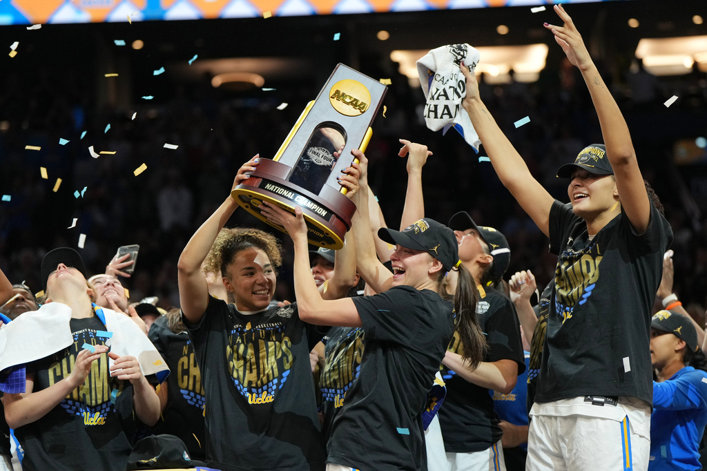 UCLA players celebrate after defeating South Carolina in the women's National Championship Final Four NCAA college basketball tournament game, Sunday, April 5, 2026, in Phoenix. (AP Photo/Rick Scuteri)