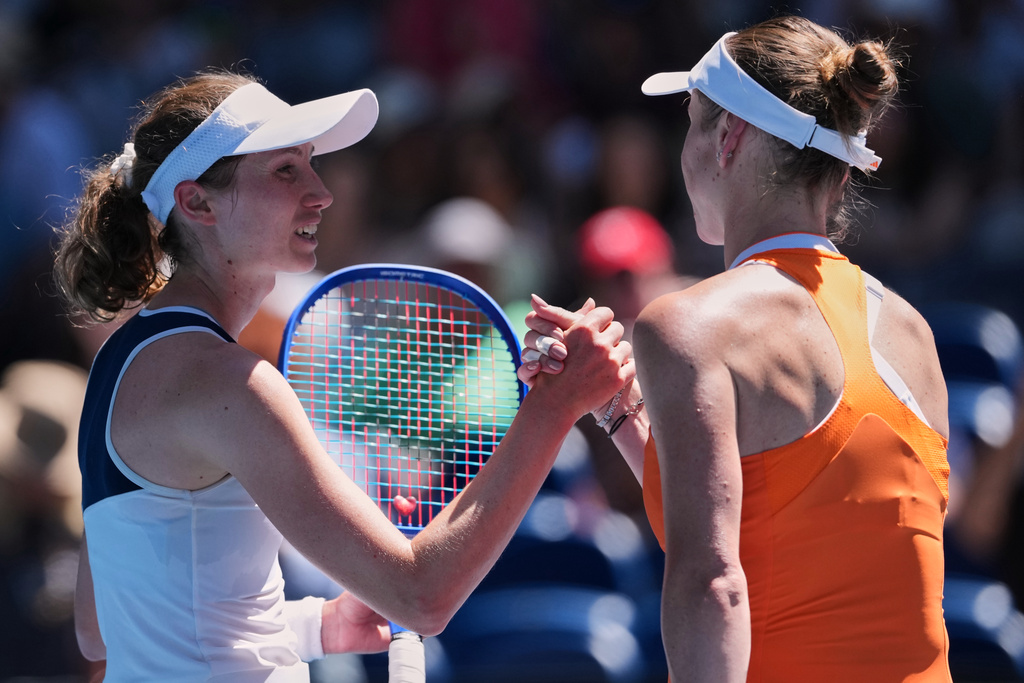 Elina Svitolina, right, of Ukraine is congratulated by Cristina Bucsa, left, of Spain during their first round match at the Australian Open tennis championship in Melbourne, Australia, Sunday, Jan. 18, 2026. (AP Photo/Aaron Favila)