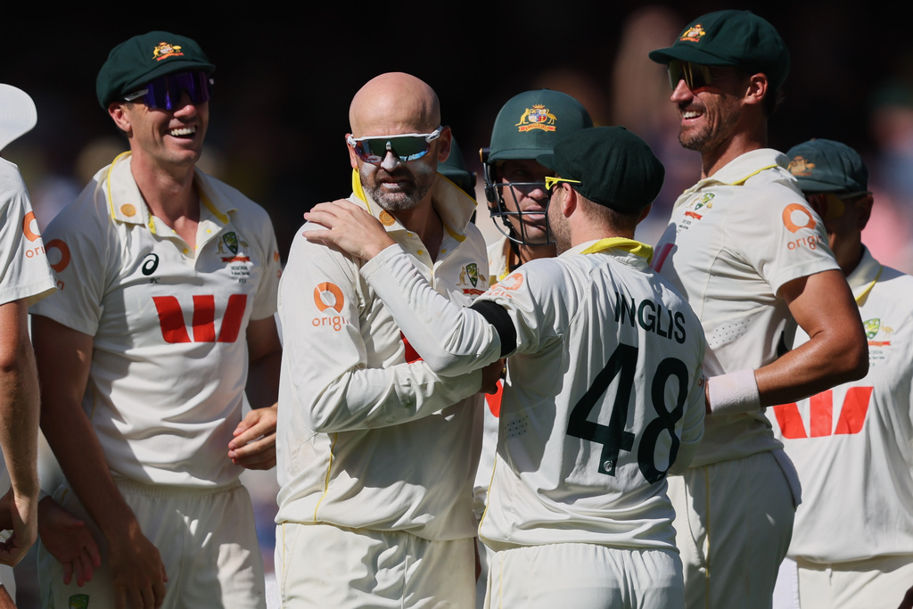 Australia's Nathan Lyon, second left, is congratulated by teammates after dismissing England's Ben Stokes during play on day four of the third Ashes cricket test between England and Australia in Adelaide, Australia, Saturday, Dec. 20, 2025. (AP Photo/James Elsby)