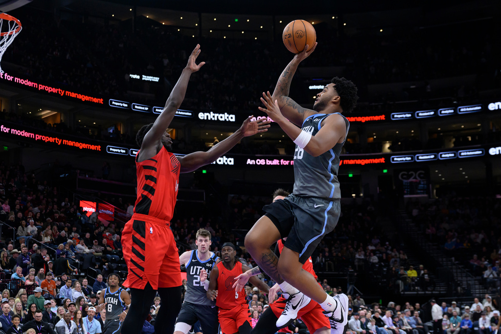 Utah Jazz forward Brice Sensabaugh, right, shoots over Portland Trail Blazers guard Sidy Cissoko, left, during the second half of an NBA basketball game, Thursday, Feb. 12, 2026, in Salt Lake City. (AP Photo/Tyler Tate)