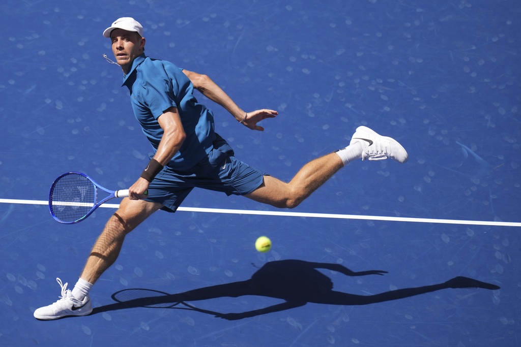 Denis Shapovalov, of Canada, returns a shot against Jannik Sinner, of Italy, during the third round of the U.S. Open tennis championships, Saturday, Aug. 30, 2025, in New York. (AP Photo/Kirsty Wigglesworth)