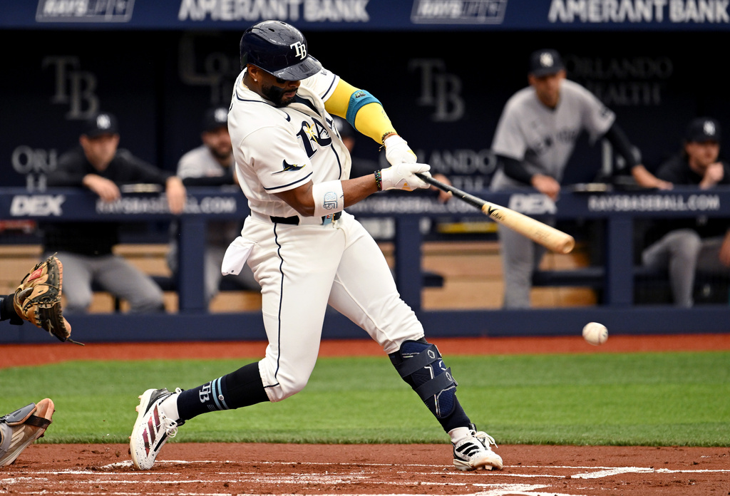 Tampa Bay Rays' Yandy Díaz hits an RBI groundout during the first inning of a baseball game against the New York Yankees, Sunday, April 12, 2026, in St. Petersburg, Fla. (AP Photo/Jason Behnken)
