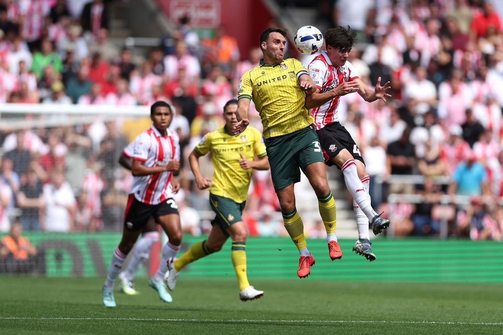 Wrexham's Matthew James and Southampton's Jay Robinson, right, vie for the ball during the English Football League Championship match at St Mary's Stadium, Southampton, England, Saturday, Aug. 9, 2025. (Steven Paston/PA via AP)