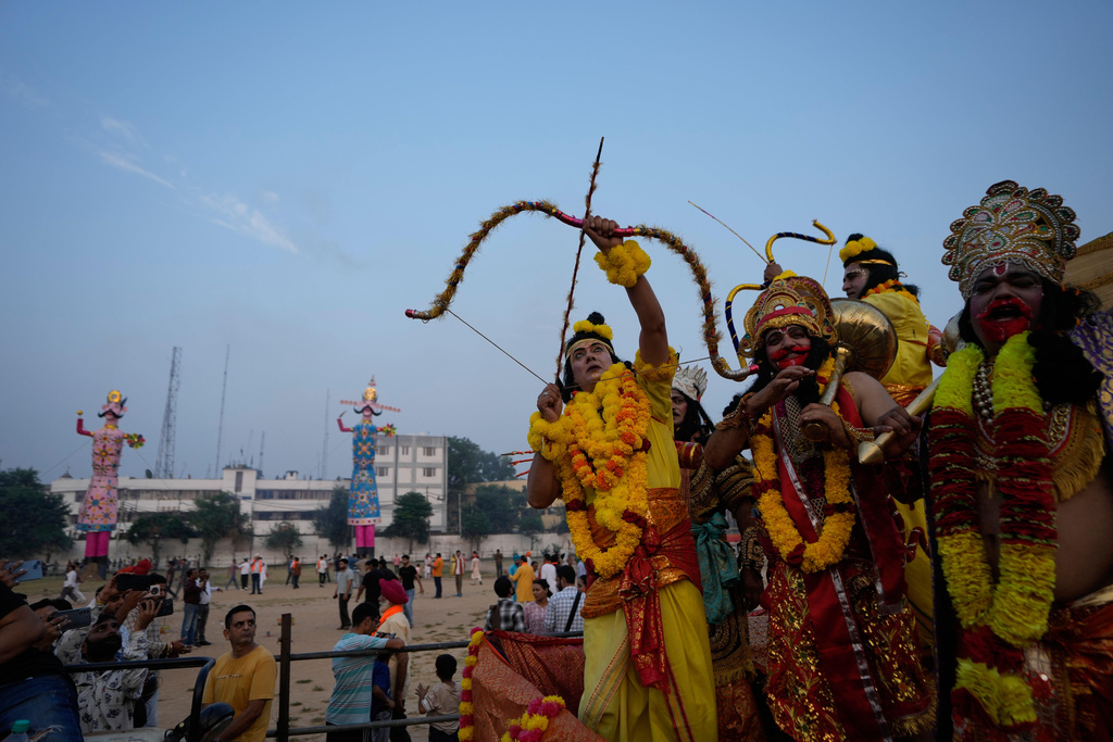 Artists dressed up as Hindu gods shout religious slogans during Dussehra festivities in Jammu, India, Thursday, Oct.2, 2025.(AP Photo/Channi Anand)