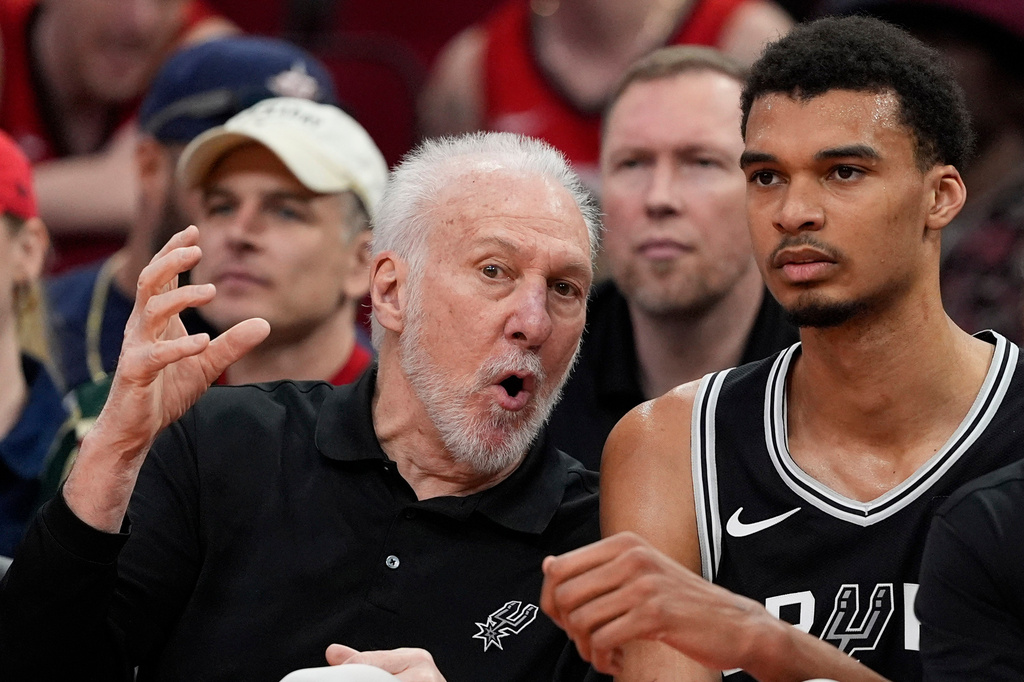 FILE - San Antonio Spurs coach Gregg Popovich, left, talks with Victor Wembanyama on the bench during the first half of an NBA basketball game against the Houston Rockets March 5, 2024, in Houston. (AP Photo/David J. Phillip, File)