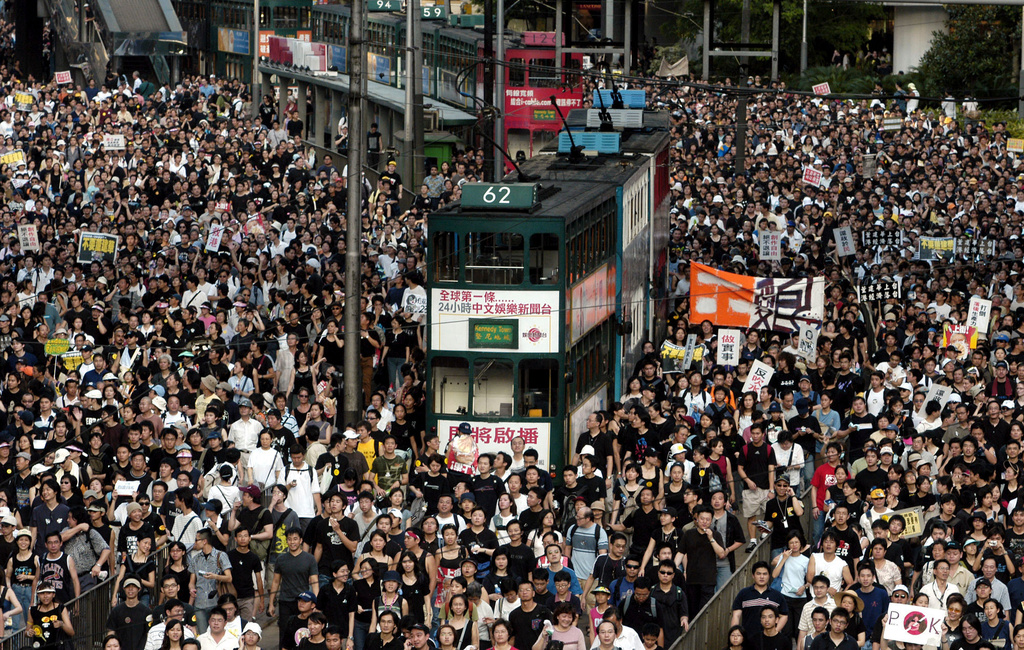 FILE - In this July 1, 2003 file photo, tens of thousands of people pack a Hong Kong street while marching to Hong Kong government headquarters to protest the Hong Kong government's plans to enact an anti-subversion bill that critics fear will curtail civil liberties. (AP Photo/Vincent Yu, File)