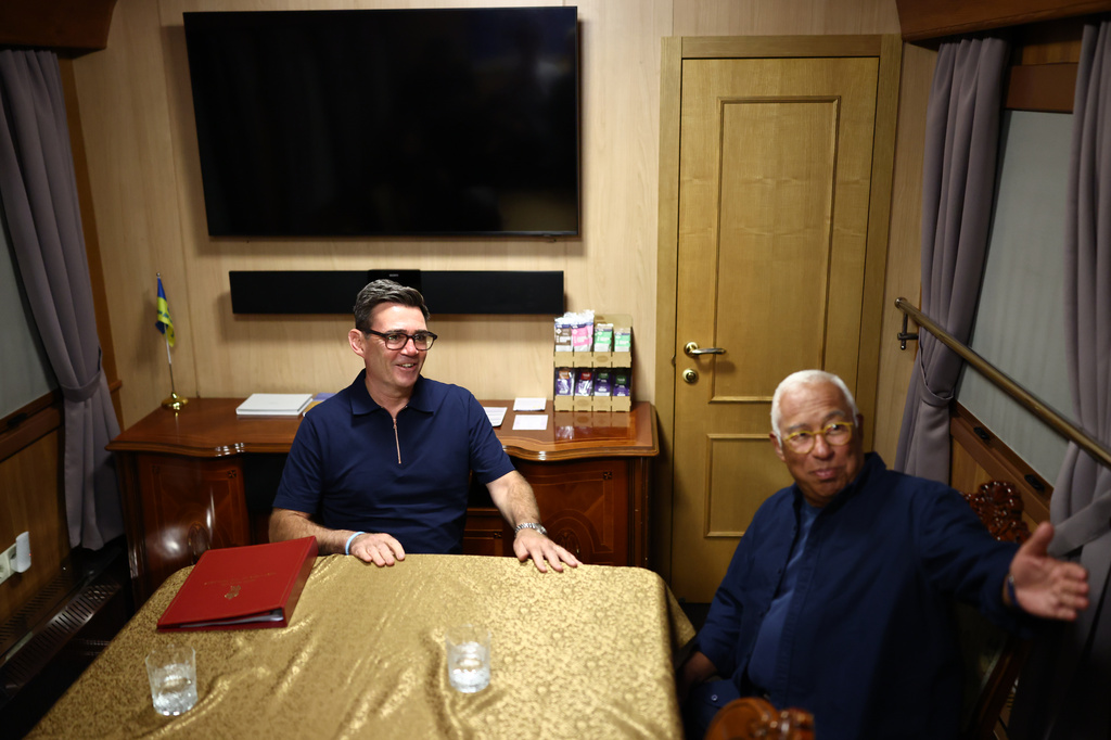 Britain's Prime Minister Andy Burnham, left, talks with President of the European Council Antonio Costa aboard a train headed to Kyiv, at an undisclosed location in Ukraine, late Sunday, Aug. 23, 2026. (Henry Nicholls/Pool Photo via AP) CORRECTION: Corrects date from Aug. 24, 2026 to Aug. 23, 2026.