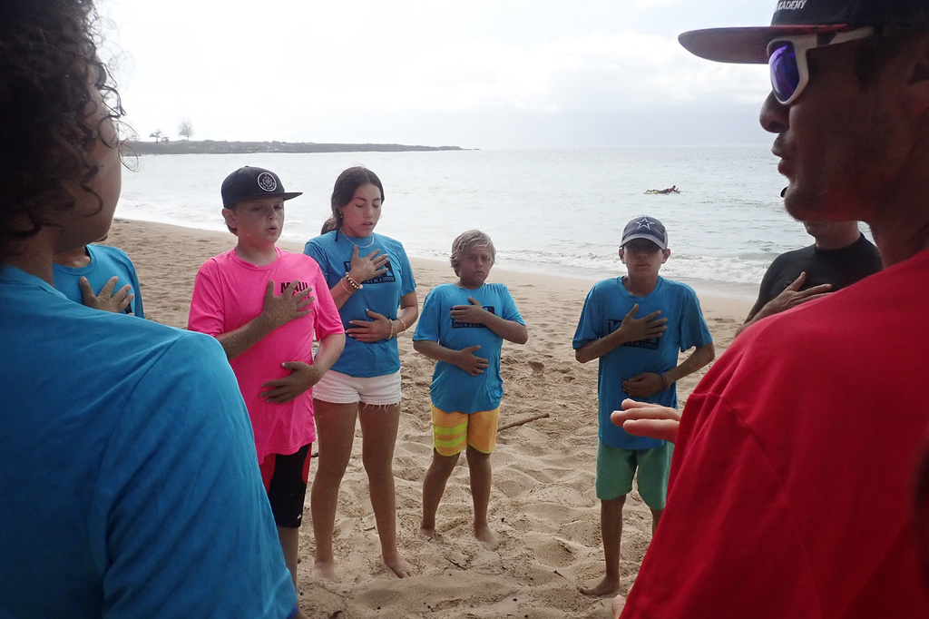 Maui Hero Project's Joseph Anderson, DayJahiah Valdivia, Ocean Viera and Ivan Macias follow Kahākūahi Ocean Academy's Zane Kekoa Schweitzer's breathing exercise to re-center themselves after the beach physical training and lifeguard skills training in Lahaina, Hawaii, on Tuesday, June 10, 2025. Anderson and Valdivia were affected by the August 2023, fires on Maui. (Kevin Fujii/Honolulu Civil Beat via AP)