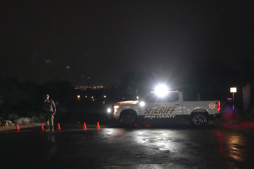 Pima County Sheriff block a road near Nancy Guthrie's home in Tucson, Ariz. on Friday, Feb. 13, 2026. (AP Photo/Ty ONeil)