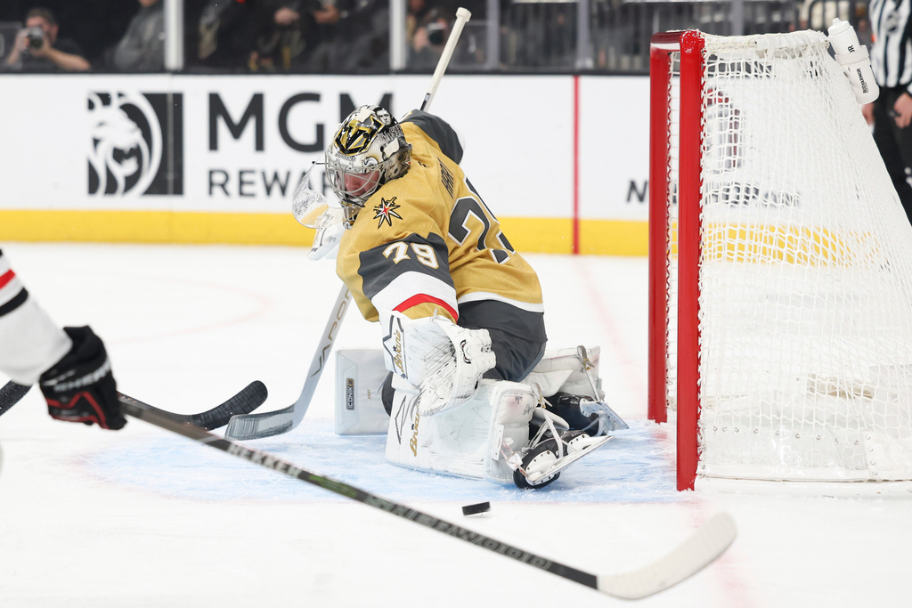 Vegas Golden Knights goaltender Carter Hart (79) makes a save against the Chicago Blackhawks during the first period of an NHL hockey game Tuesday, Dec. 2, 2025, in Las Vegas. (AP Photo/Ian Maule)