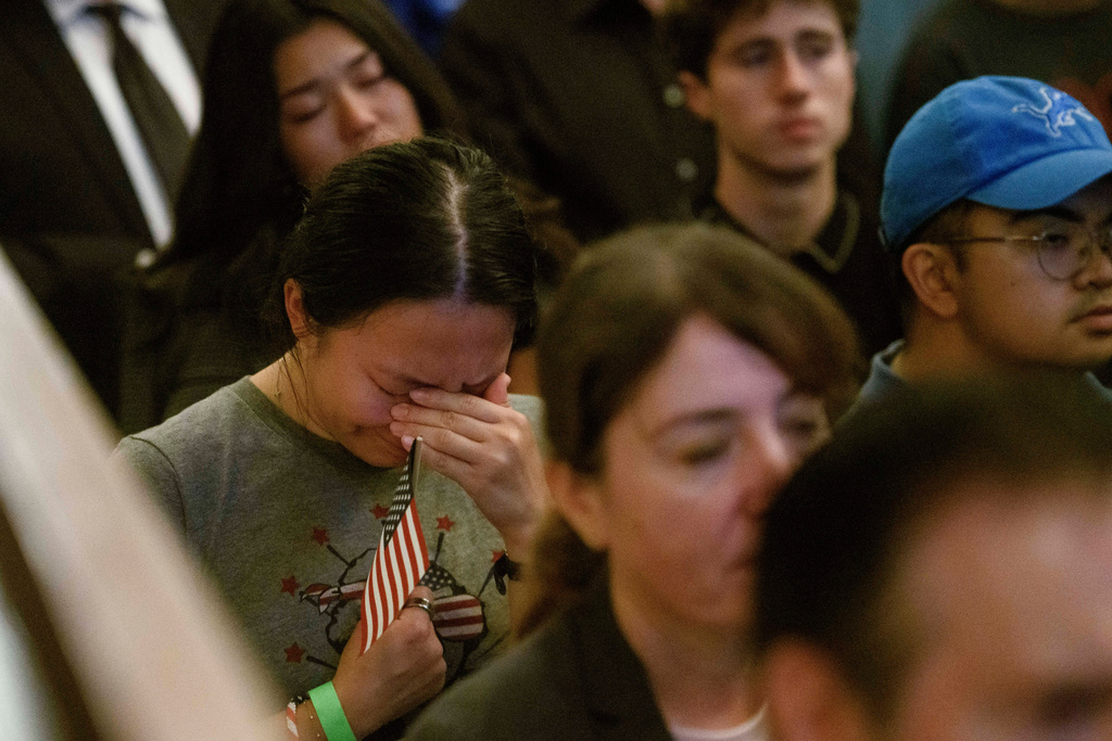 People sing and pray during a memorial and prayer vigil for Charlie Kirk at the John F. Kennedy Memorial Center for the Performing Arts, Sunday, Sept. 14, 2025, in Washington. (AP Photo/Rod Lamkey, Jr.)