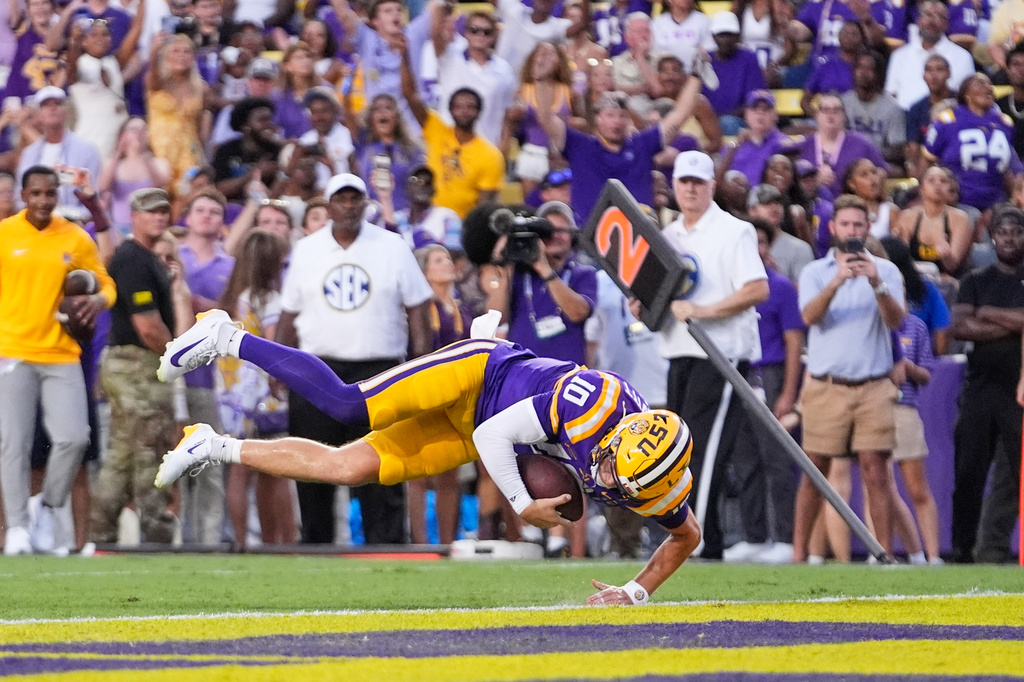 LSU quarterback Sam Leavitt (10) dives into the end zone on a touchdown carry against Louisiana Tech in the first half of an NCAA college football game, Saturday, Sept. 12, 2026 in Baton Rouge, La. (AP Photo/Gerald Herbert)