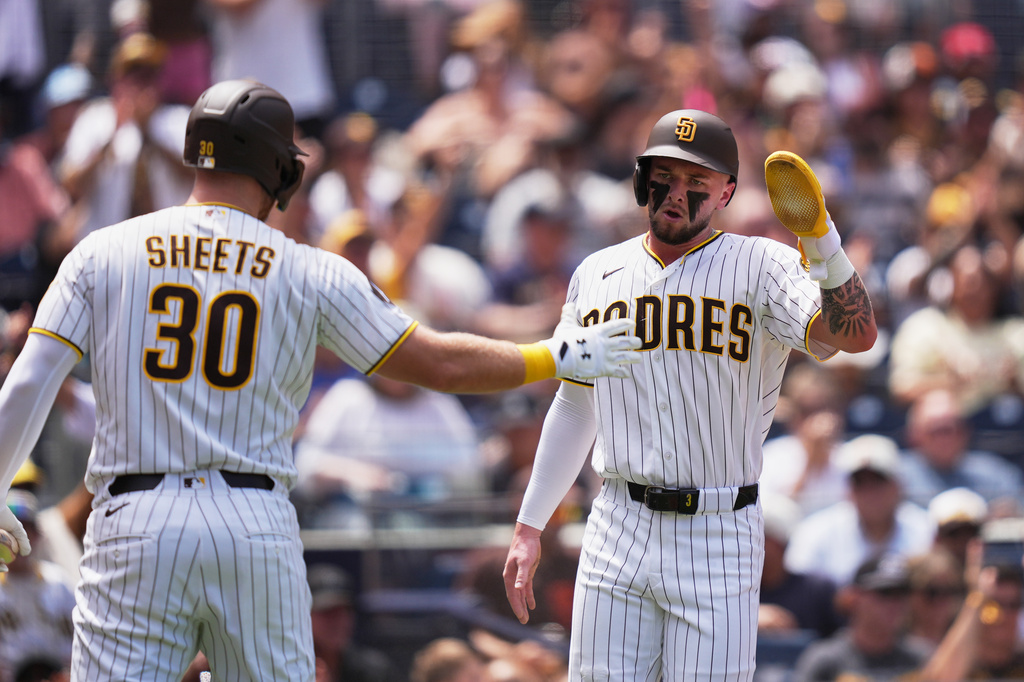 San Diego Padres' Jackson Merrill, right, celebrates with teammate Gavin Sheets after scoring from second base off an RBI single by Luis Rengifo during the second inning of a baseball game against the Pittsburgh Pirates Wednesday, Aug. 26, 2026, in San Diego. (AP Photo/Gregory Bull)