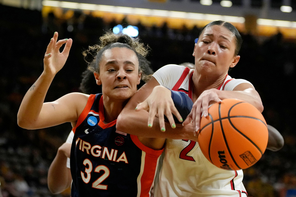Virginia forward Breona Hurd (32) fights for a rebound with Georgia guard Savannah Henderson (2) during the second half in the first round of the NCAA college basketball tournament, Saturday, March 21, 2026, in Iowa City, Iowa. (AP Photo/Charlie Neibergall)