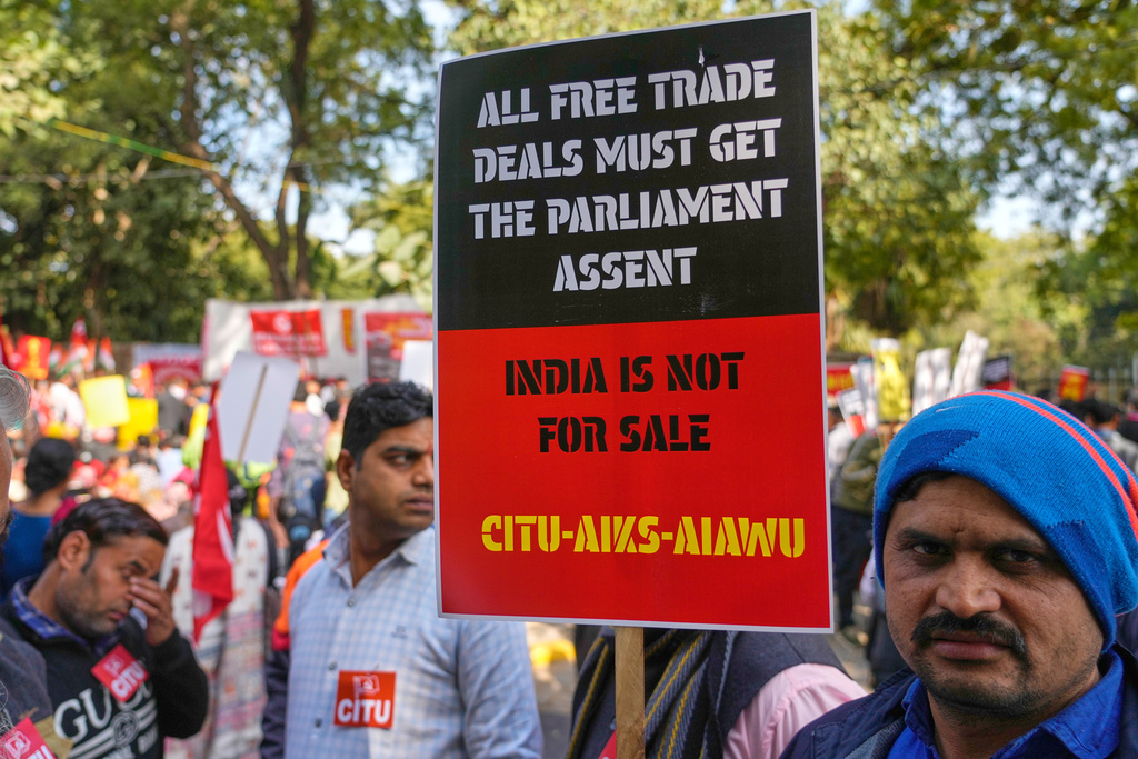 Members of trade unions hold banners during a nationwide strike to protest an interim trade deal with the United States, saying the agreement undermines the interests of farmers, small businesses and workers in New Delhi, India, Thursday, Feb. 12, 2026. (AP Photo/Manish Swarup)