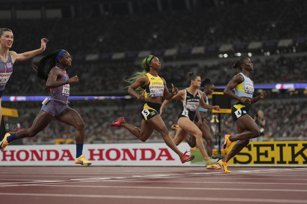 Jamaica's Shelly-Ann Fraser-Pryce (5) runs in a women's 100 meters semifinal at the World Athletics Championships in Tokyo, Sunday, Sept. 14, 2025. (AP Photo/Bernat Armangue)