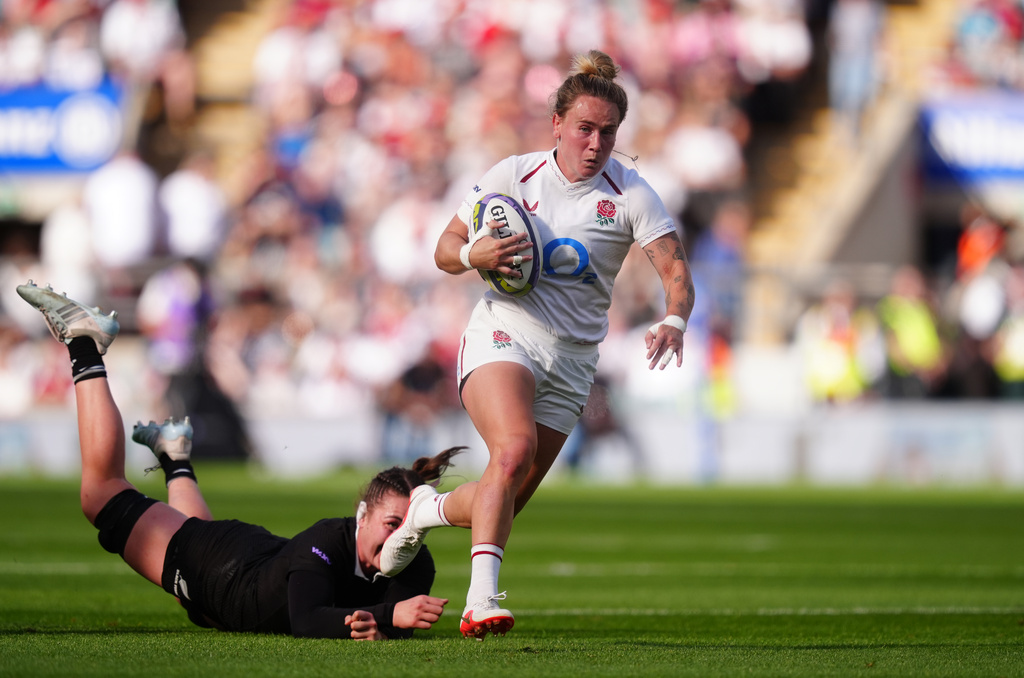 England's Megan Jones gets past the tackle of New Zealand's Maiakawanakaulani Roos during the WXV Global Series match between England and New Zealand in London, Saturday Sept. 26, 2026. (David Davies/PA via AP)