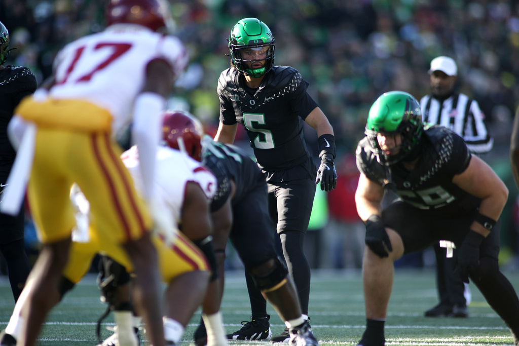 Oregon quarterback Dante Moore (5) calls instructions during the first half of an NCAA college football game against Southern California, Saturday, Nov. 22, 2025, in Eugene, Ore. (AP Photo/Lydia Ely)