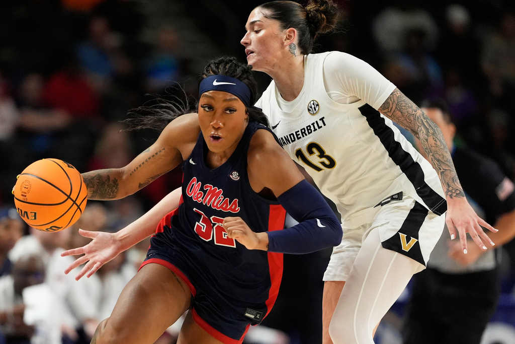 Ole Miss forward Cotie McMahon drives past Vanderbilt guard Justine Pissott during first half of an NCAA college basketball game in the quarterfinals of the Southeastern Conference tournament, Friday, March 6, 2026, in Greenville, S.C. (AP Photo/Chris Carlson)