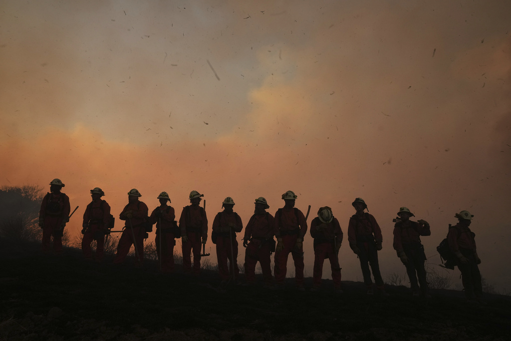 A California Department of Corrections fire crew looks on as the Canyon Fire burns on Thursday, Aug. 7, 2025, in Hasley Canyon, Calif. (AP Photo/Marcio Jose Sanchez)