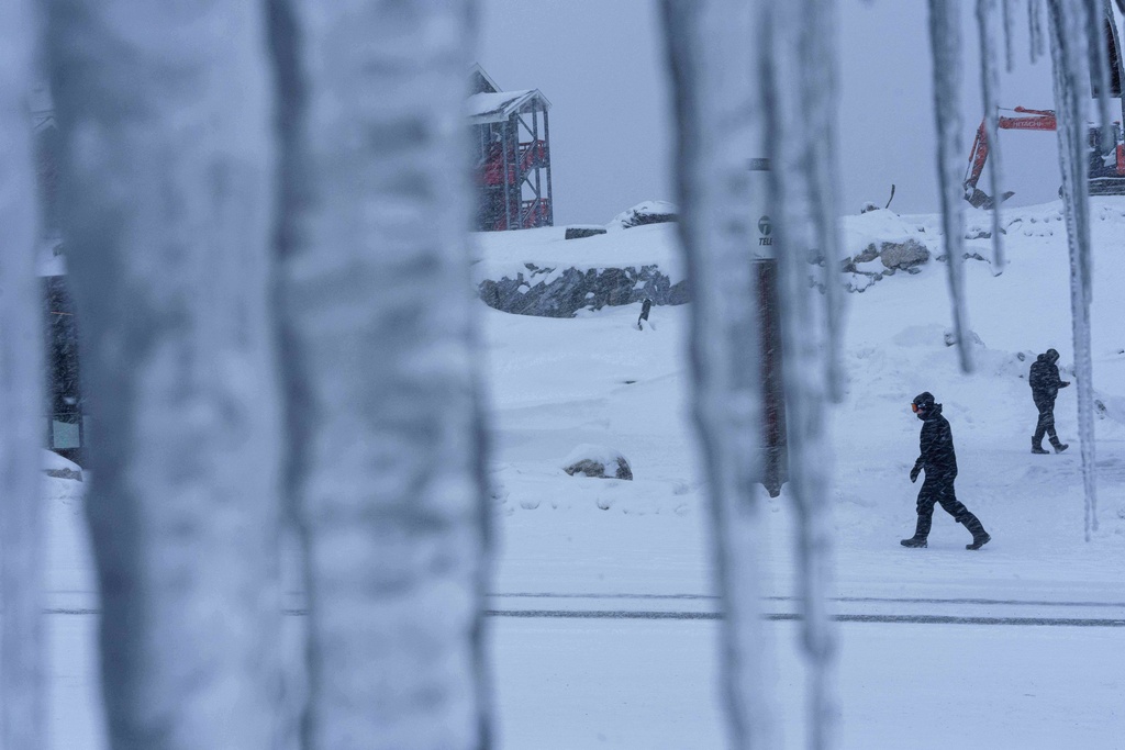 People walk through the snow in Nuuk, Greenland, Monday, Jan. 19, 2026. (AP Photo/Evgeniy Maloletka)