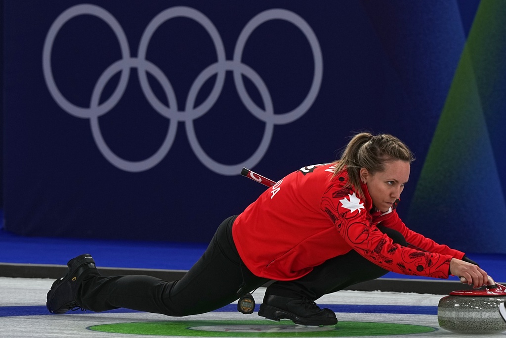 Canada's Rachel Homan in action during the women's curling round robin session against Switzerland at the 2026 Winter Olympics, in Cortina d'Ampezzo, Italy, Saturday, Feb. 14, 2026. (AP Photo/Fatima Shbair)
