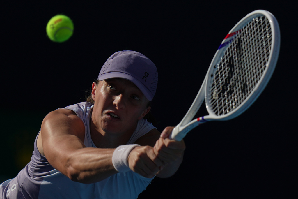 Iga Swiatek, of Poland plays a backhand return to Camila Osorio, of Colombia during the women's singles match for the China Open tennis tournament, in Beijing, Monday, Sept. 29, 2025. (AP Photo/Andy Wong)