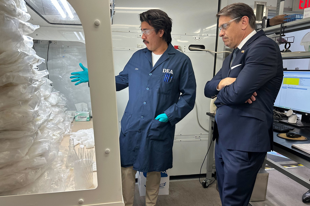 Acting Attorney General Todd Blanche talks to a technician in a Drug Enforcement Administration (DEA) mobile lab who is running tests on seized drugs in Phoenix, Wednesday, May 6, 2026. (AP Photo/Rebecca Santana)