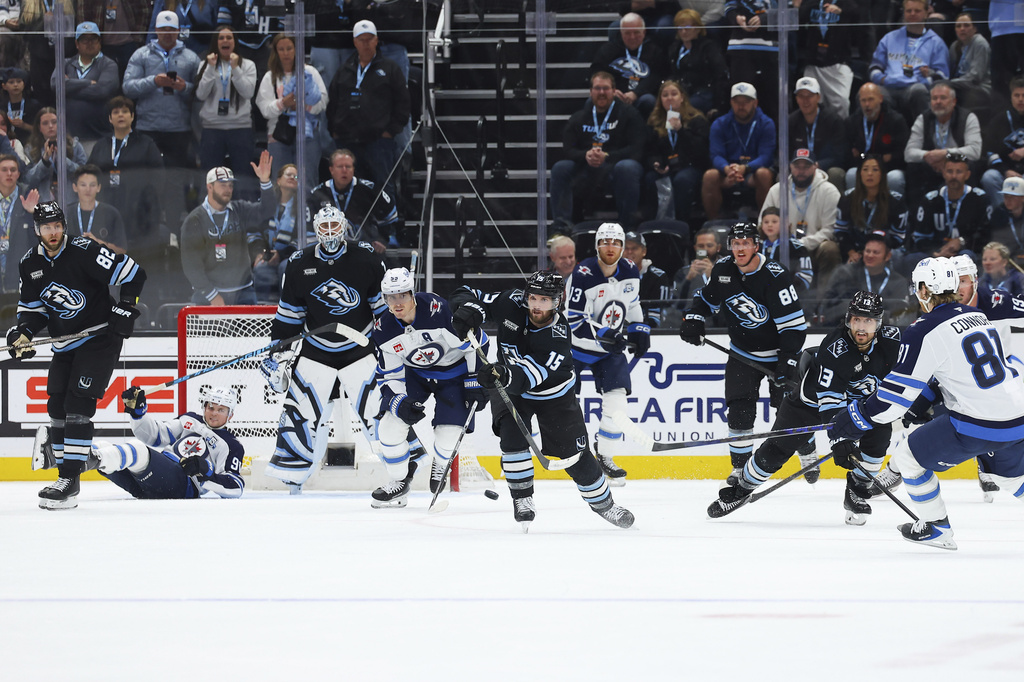 Utah Mammoth center Alexander Kerfoot (15) shoots the puck to score during the third period of an NHL hockey game against the Winnipeg Jets, Tuesday, April 14, 2026, in Salt Lake City. (AP Photo/Melissa Majchrzak)