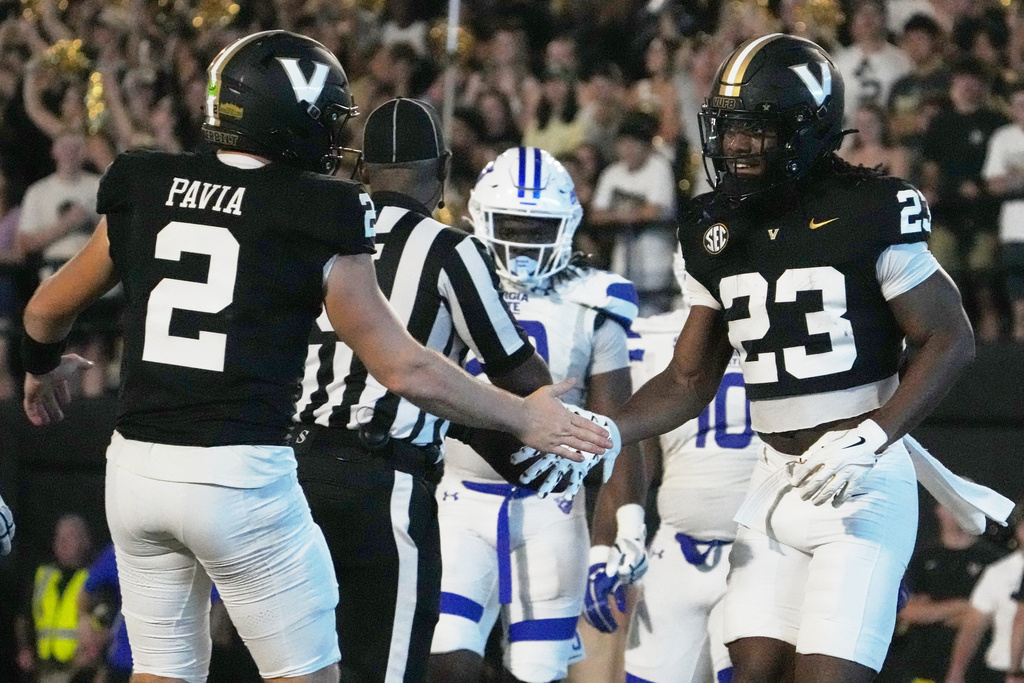 Vanderbilt quarterback Diego Pavia (2) congratulates running back AJ Newberry (23) after a touchdown during the first half of an NCAA college football game against Georgia State, Saturday, Sept. 20, 2025, in Nashville, Tenn. (AP Photo/George Walker IV)
